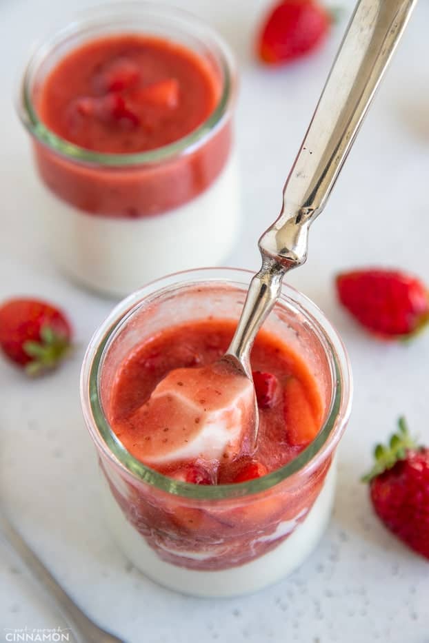 a spoon dipping into a small jar with homemade dairy-free coconut panna cotta