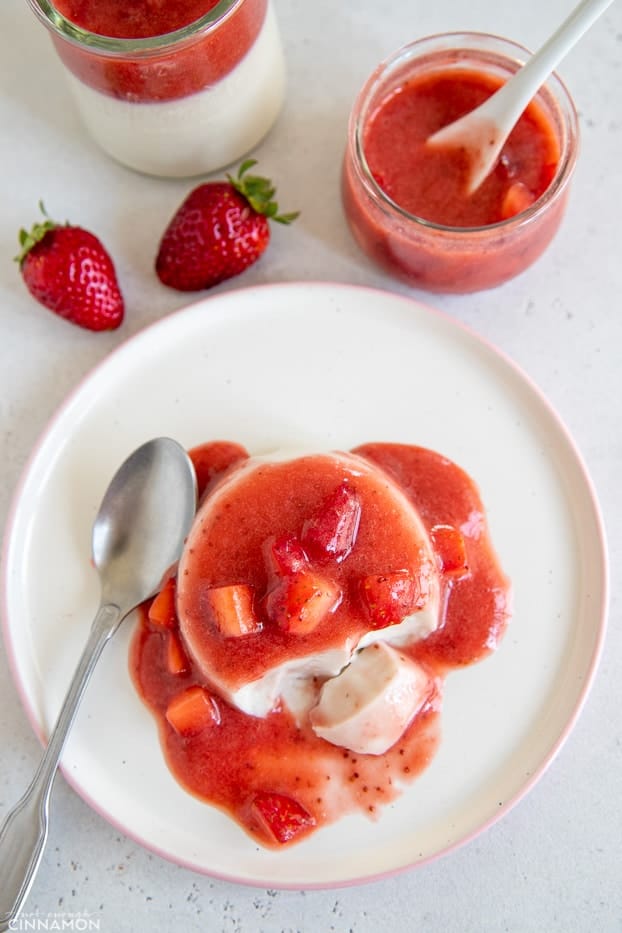 overhead shot of serving of coconut milk panna cotta topped with fresh strawberry compote 