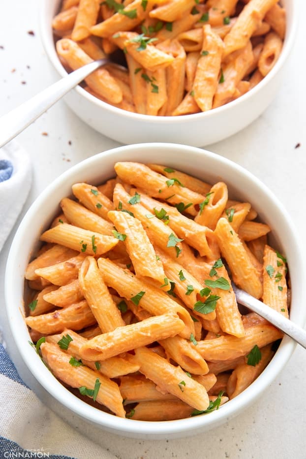 two servings of dairy free penne alla vodka served in pasta bowls