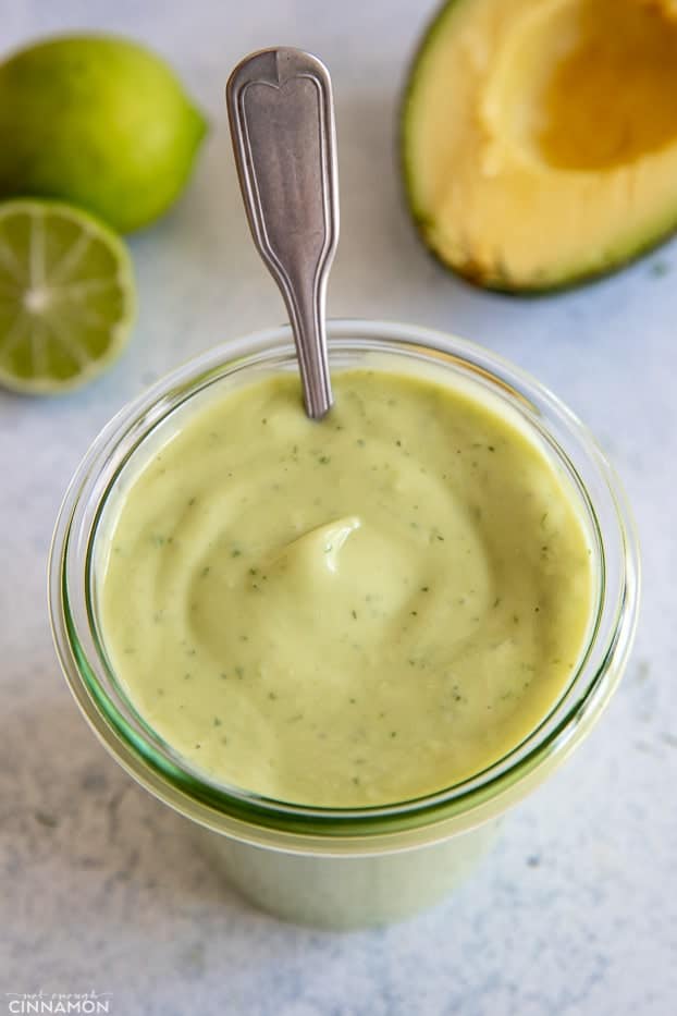 a small spoon in a jar with homemade vegan Avocado Ranch dressing