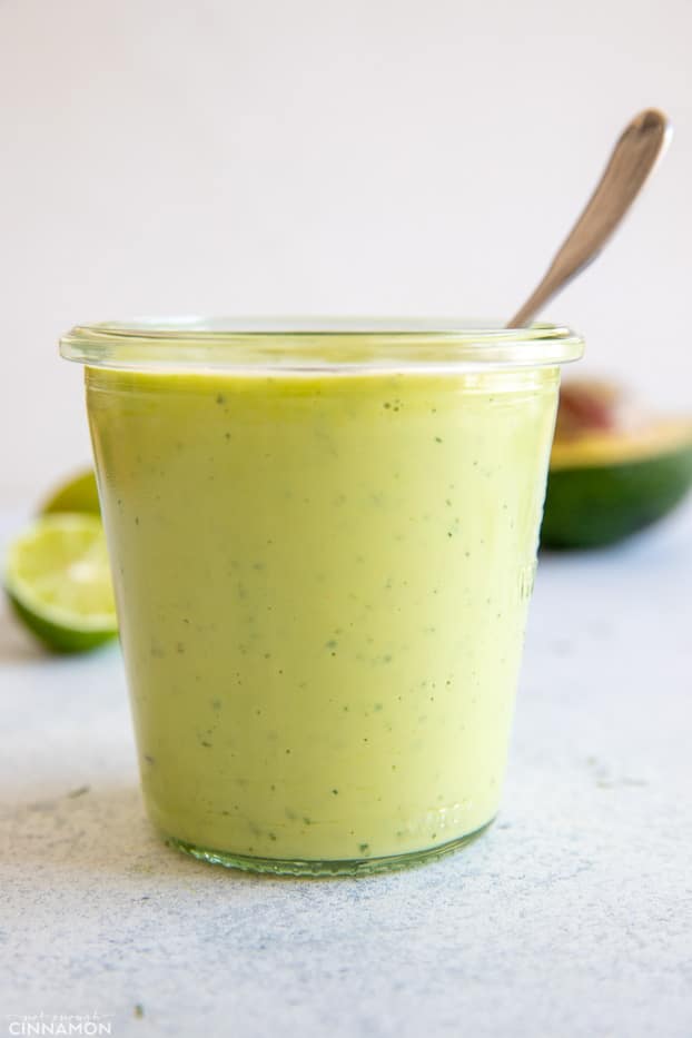 side view of vegan avocado ranch dressing in a small mason jar