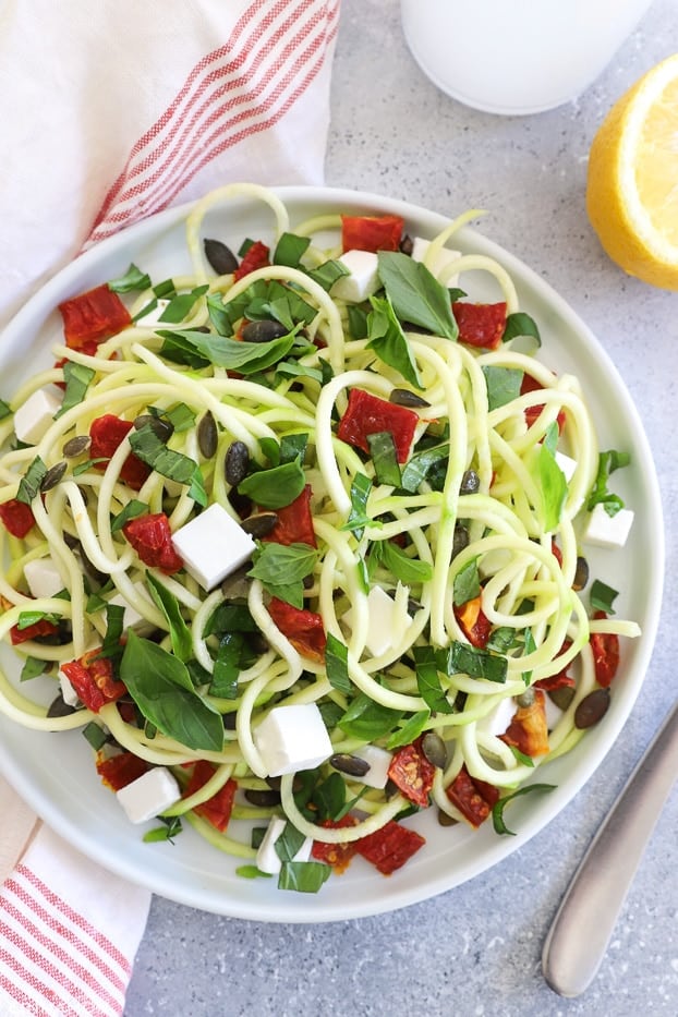 overhead shot of zucchini salad with sundried tomaties and goat cheese