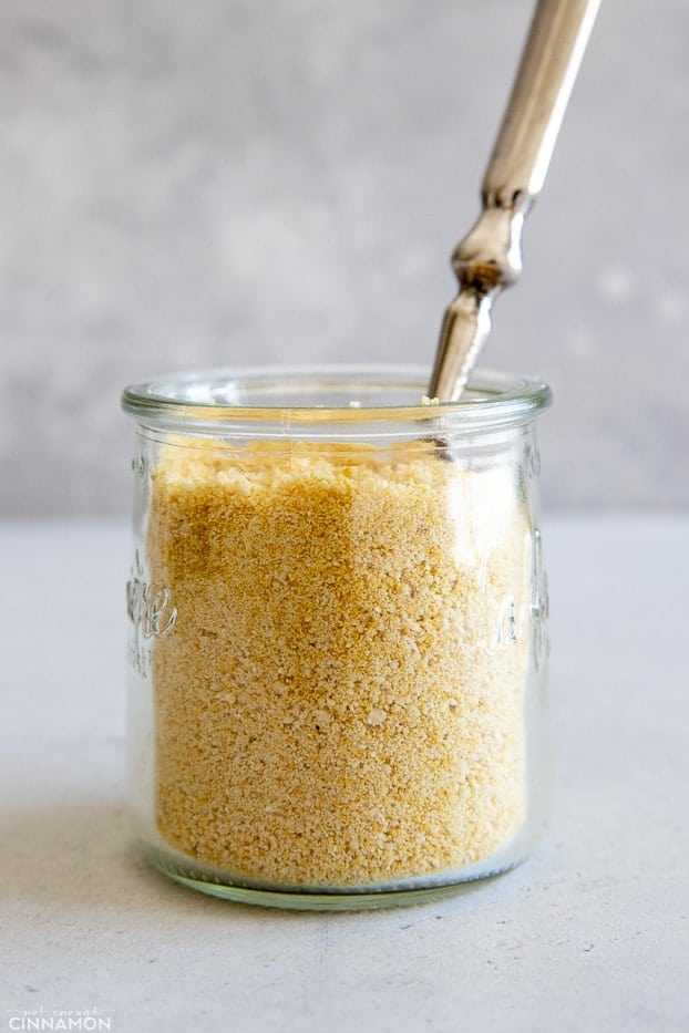 side view of a jar of vegan parmesan cheese 