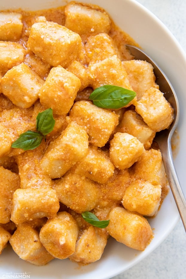 overhead shot of homemade cauliflower gnocchi tossed with sun-dried tomato sauce