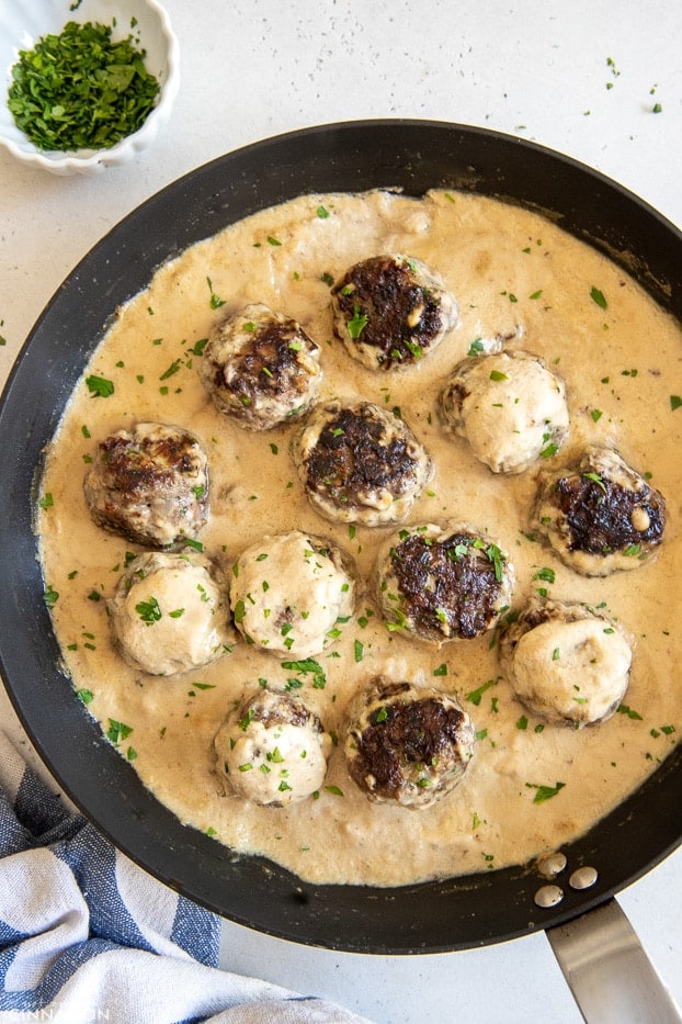 overhead shot of a skillet with paleo Swedish Meatballs in creamy cashew gravy 