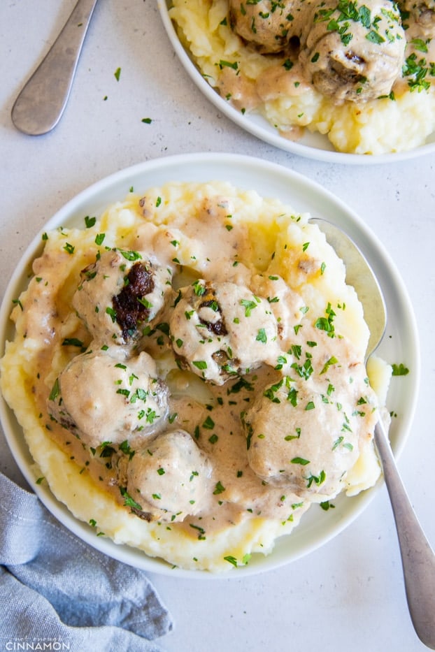 a plate with cauliflower mash topped with Paleo beef meatballs and dairyfree gravy