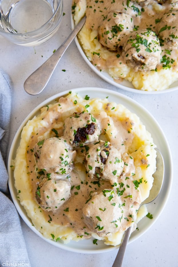 two servings of paleo Swedish Meatballs in dairyfree cashew gravy served over cauliflower mash 