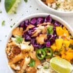 overhead shot of a healthy whole30 paleo fish taco bowl with cilantro lime cauliflower rice