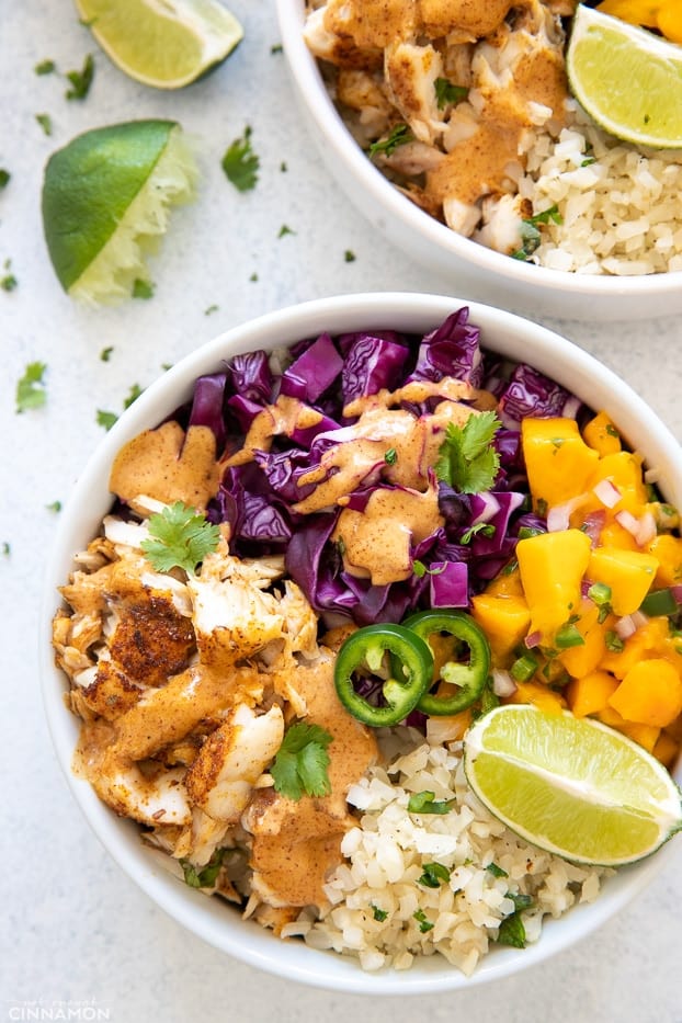 overhead shot of a healthy whole30 paleo fish taco bowl with cilantro lime cauliflower rice