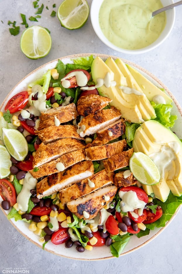 overhead shot of restaurant-style Southwestern Chicken Salad drizzled with Avocado Ranch Dressing 