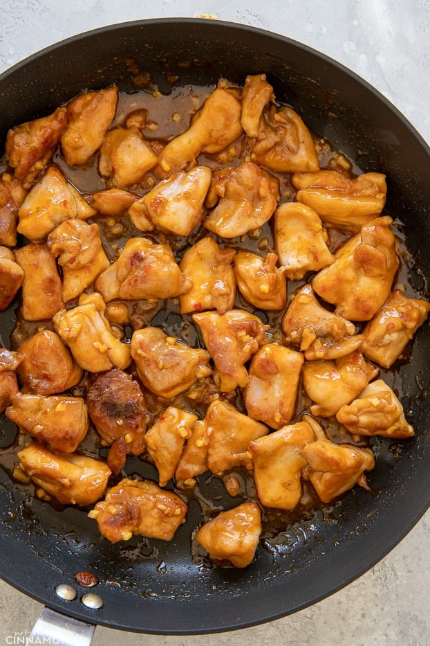 overhead shot of a black skillet with peanut butter chicken 