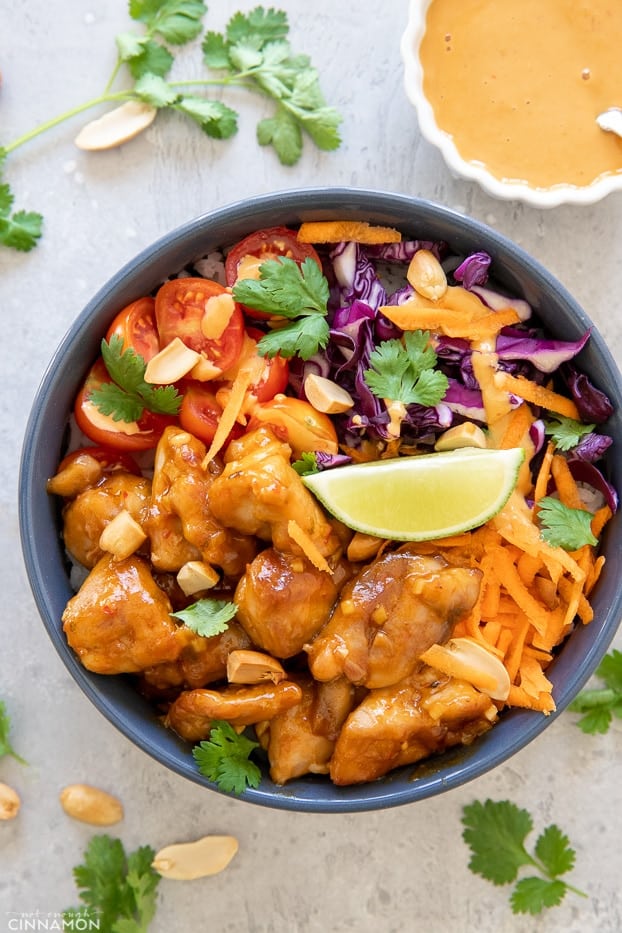 overhead shot of a bowl with veggies and Thai peanut butter chicken 