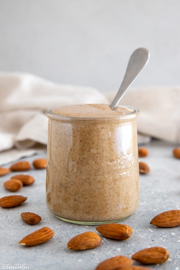 a jar of almond butter with a spoon