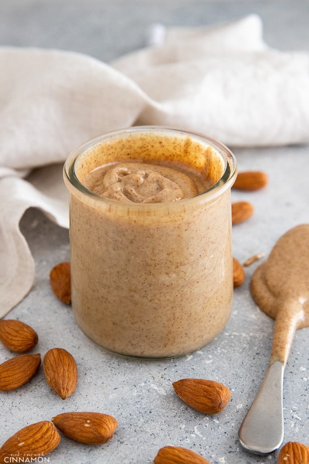 a jar of easy homemade almond butter with a spoon 