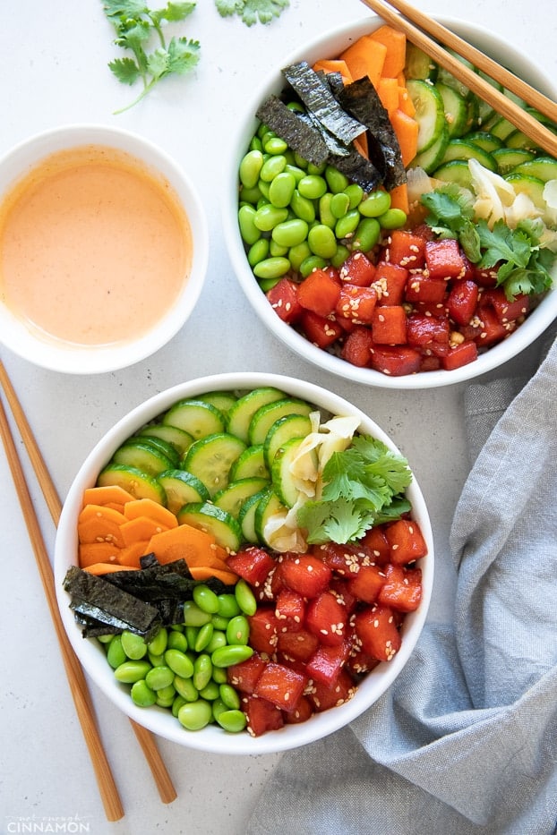 overhead shot of two vegan poke bowls with watermelon tuna served with sriracha mayo