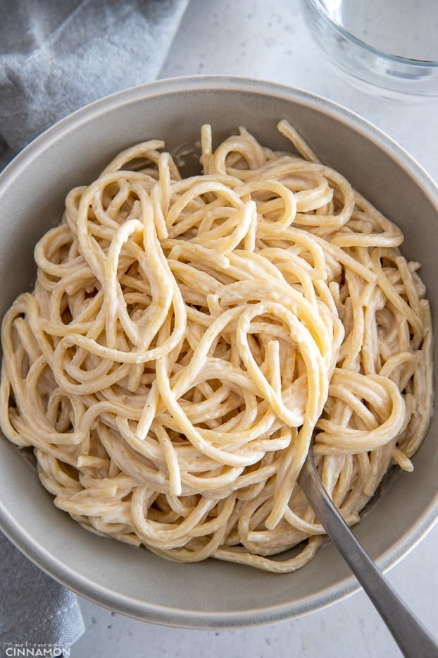overhead shot of creamy vegan pasta tossed with garlic lemon tahini sauce