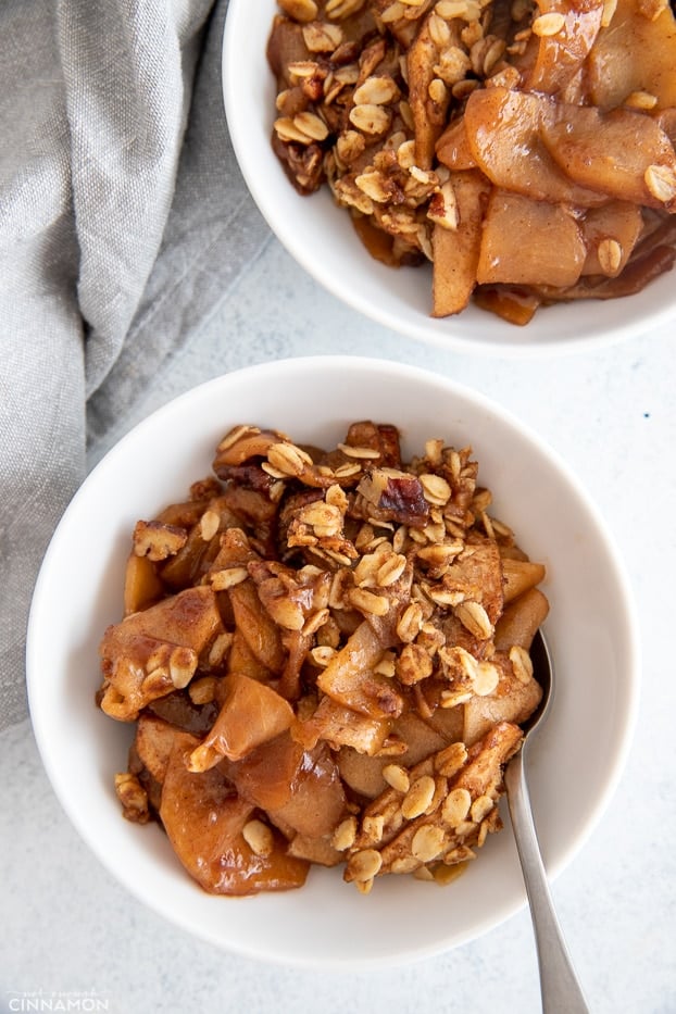 overhead shot of a serving of healthy apple crisp with a spoon on the side