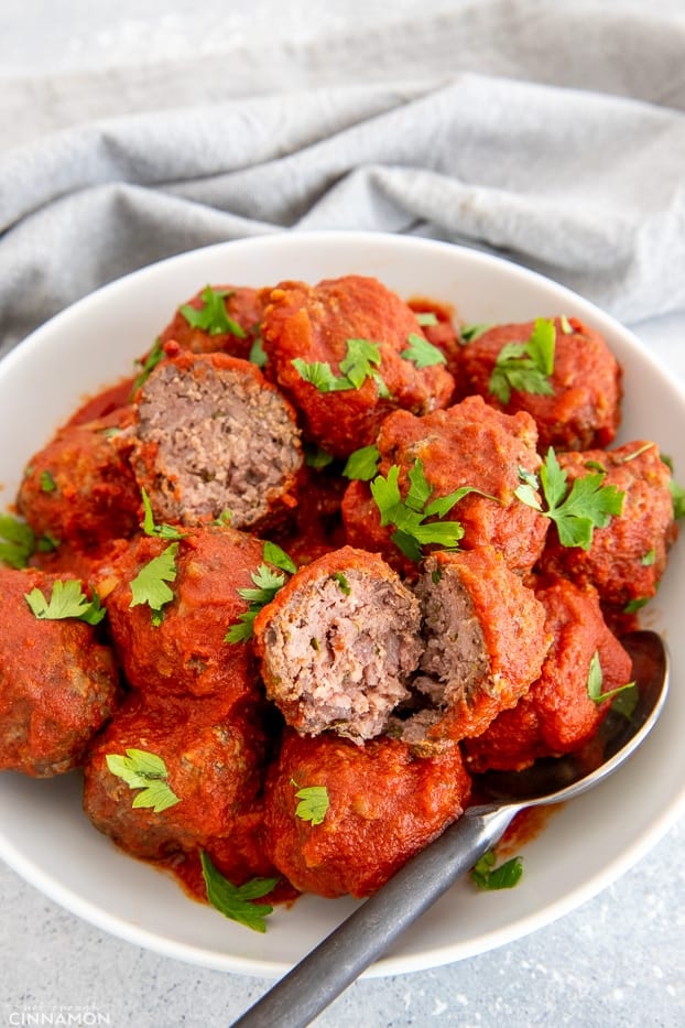 side view of healthy BBQ Slow Cooker Meatballs served with Marinara Sauce 