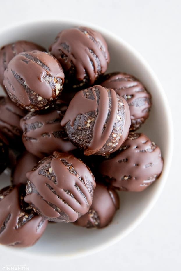 overhead shot of a bowl of vegan gingerbread energy bites coated with chocolate 
