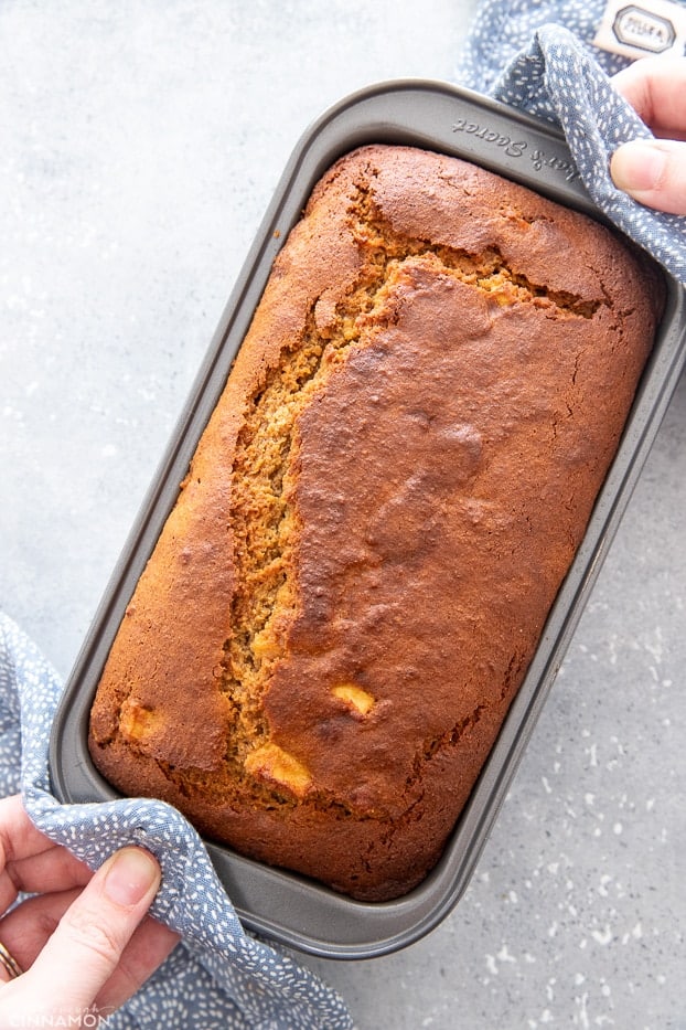 paleo apple bread being held in two hands