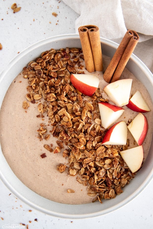 overhead shot of a healthy smoothie bowl topped with granola and fresh fruit 