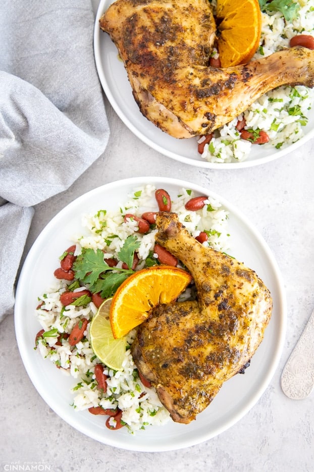 two servings of Roasted Cuban mojo chicken legs over Cuban beans and rice