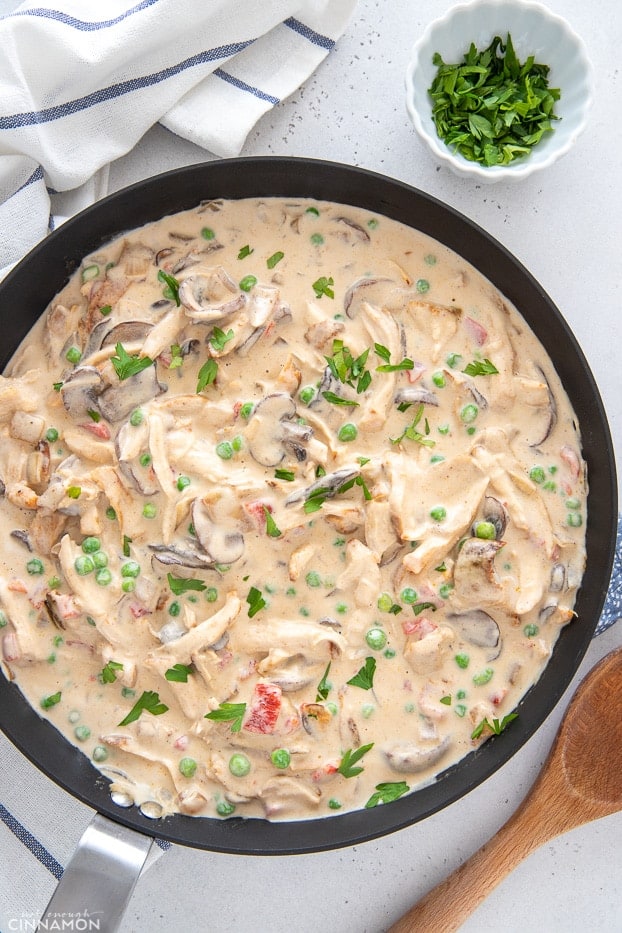overhead shot of a skillet with creamy chicken a la king 