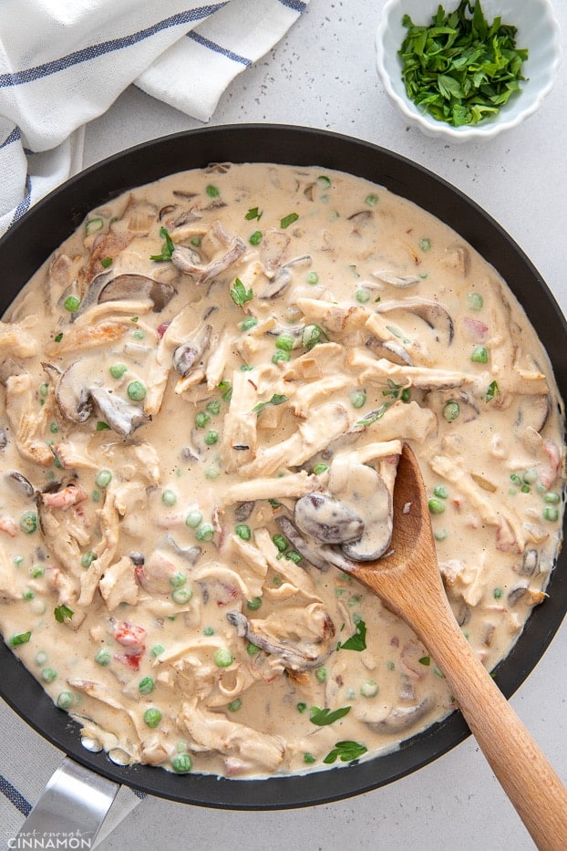 a black skillet with creamy dairyfree chicken a la king with a wooden spoon 