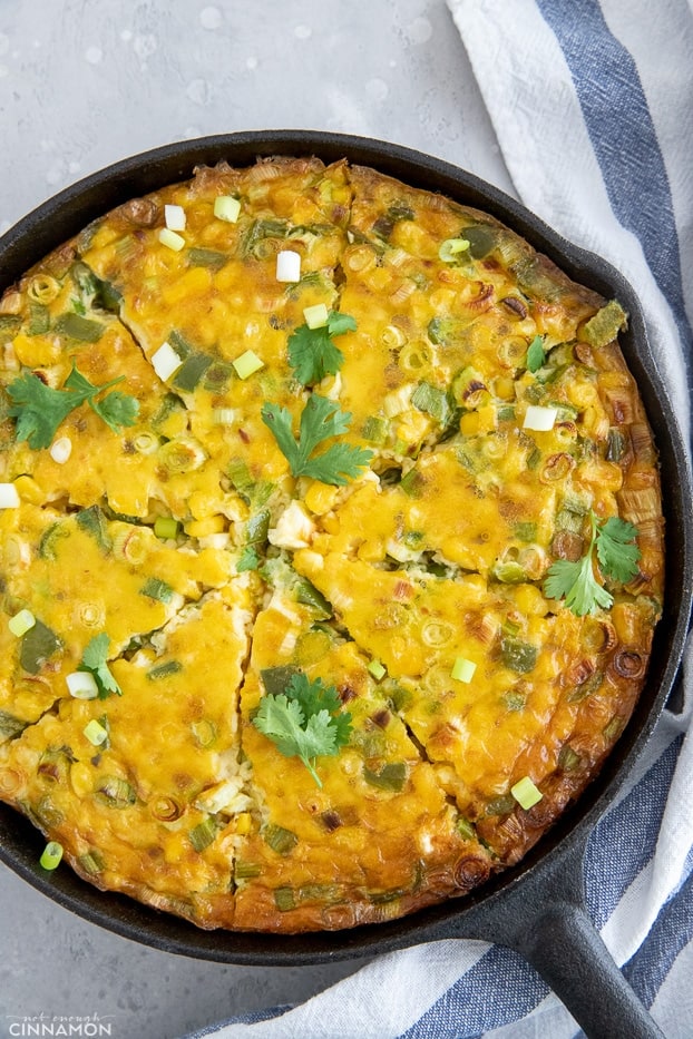 overhead shot of a dairy-free chile corn casserole in a cast iron skillet 