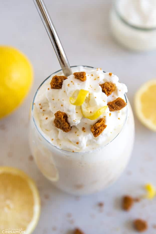 overhead shot of a healthy vegan lemon protein shake topped with coconut whipped cream and graham crackers