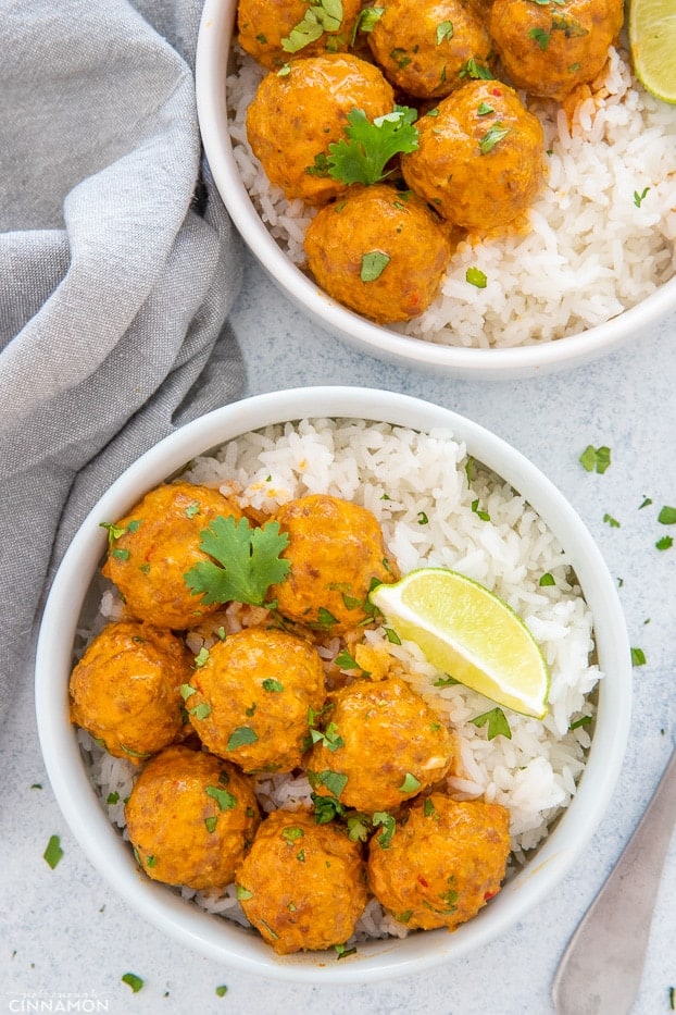 thai coconut meatballs curry served with rice and lime wedges