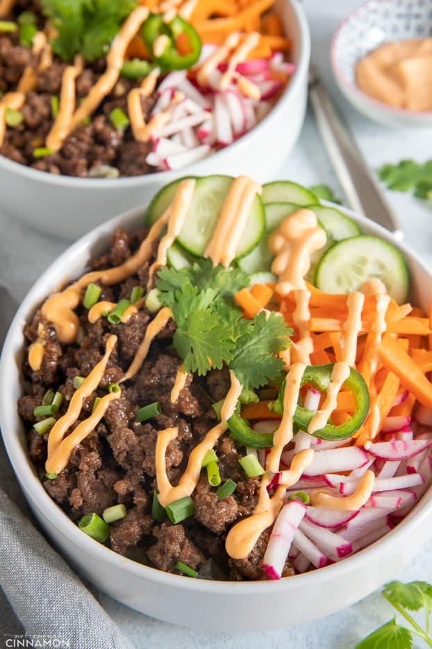 close-up of a Paleo Vietnamese Banh Mi Rice Bowl drizzled with sriracha mayo 