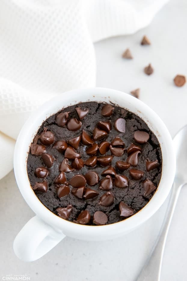 overhead shot of a vegan chocolate mug cake with chocolate chips 