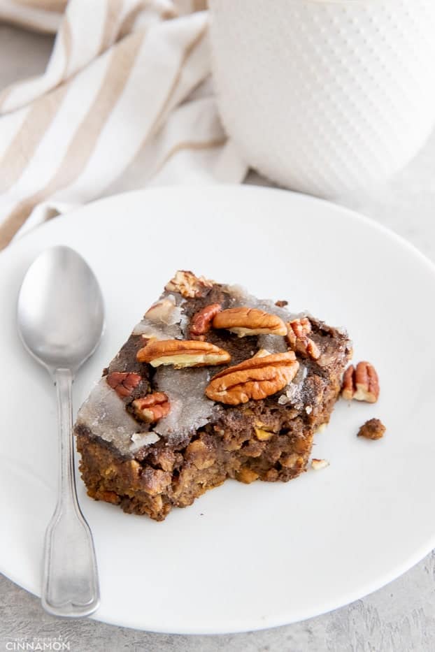 a half eaten square of vegan gingerbread baked oatmeal with a spoon on the side