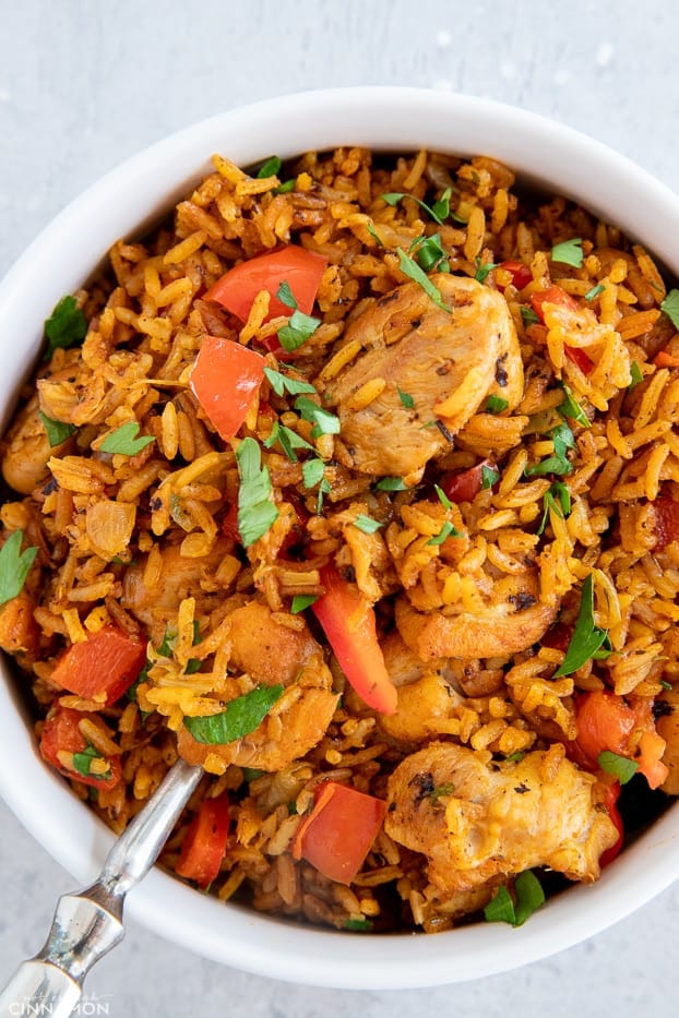 a serving of healthy African Jollof Rice with chunks of chicken and red bell pepper