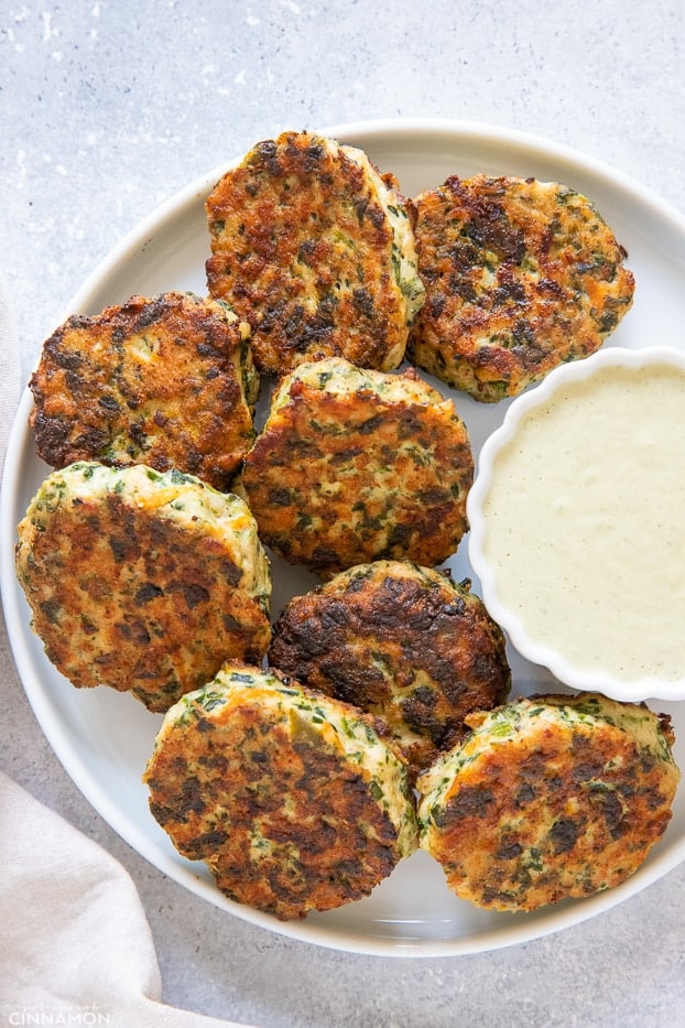 paleo chicken poppers on a white plate served with a small dish with paleo ranch dip