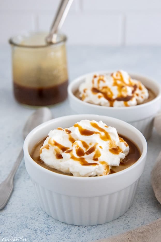 side view of a vegan salted caramel pudding topped with coconut whipped cream
