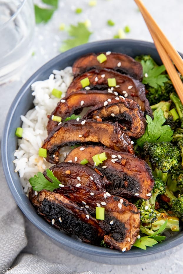 side view of vegan healthy mushroom rice bowl topped with teriyaki glazed mushrooms and broccoli