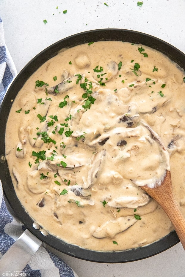 creamy vegan mushroom stroganoff sauce in a skillet 