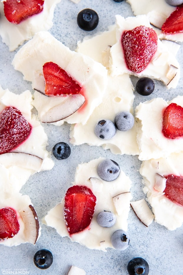overhead shot of healthy frozen yogurt bark with blueberries and strawberries