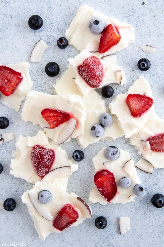 overhead shot of frozen yogurt bark topped with strawberries and blueberries