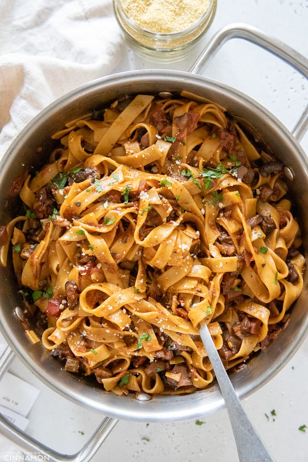 a pot of vegan mushroom bolognese mixed with fettuccine