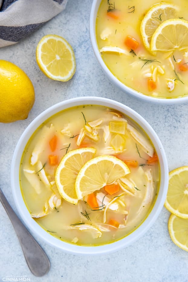 overhead shot of a two bowls of Greek Lemon Soup with Chicken and Orzo 