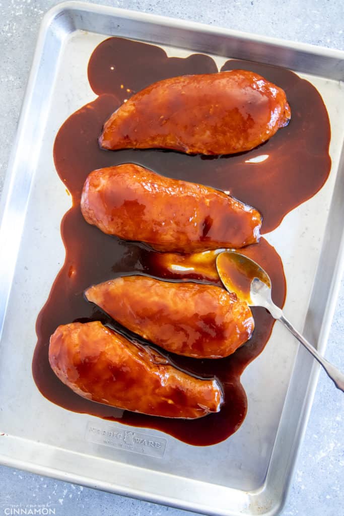 chicken breasts on a sheet pan smothered with healthy firecracker sauce 