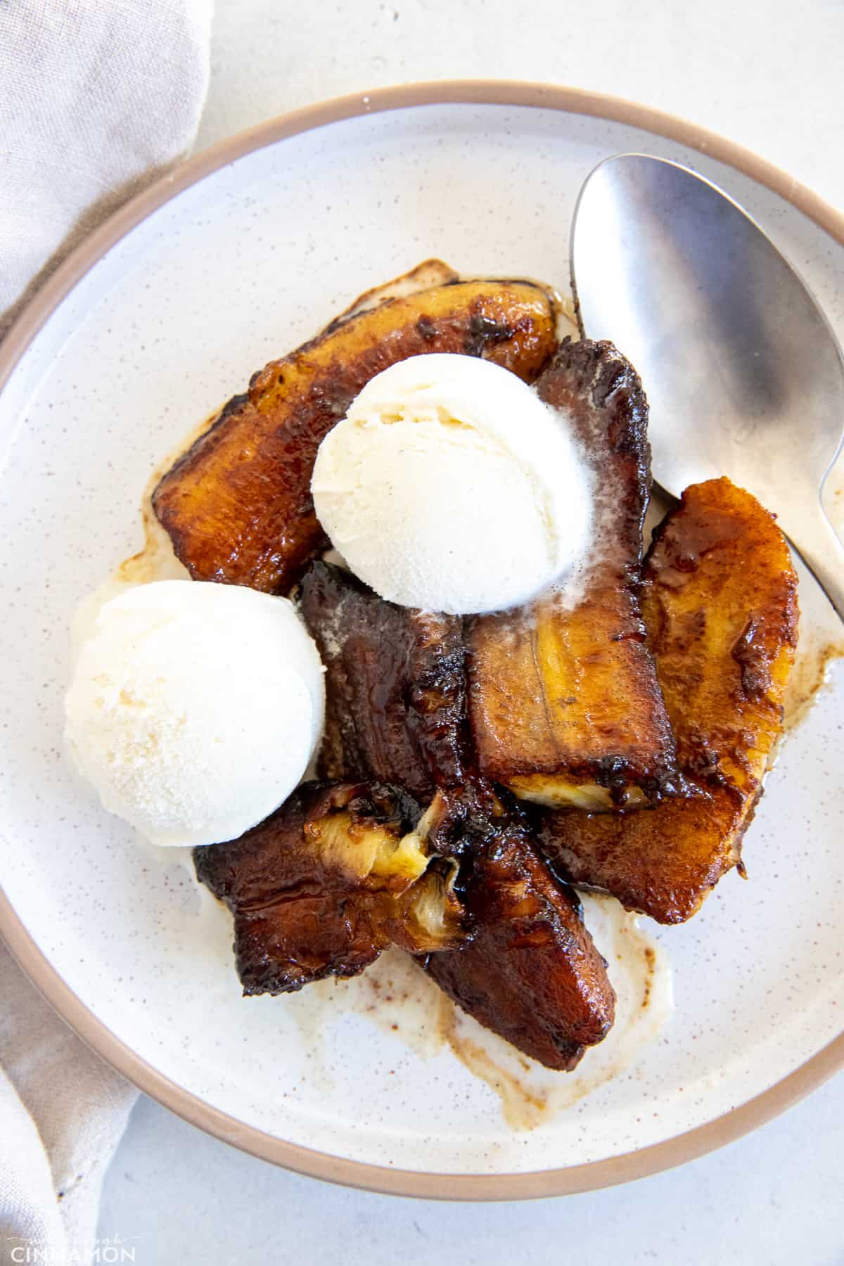 a plate with healthy banana foster topped with vanilla ice cream