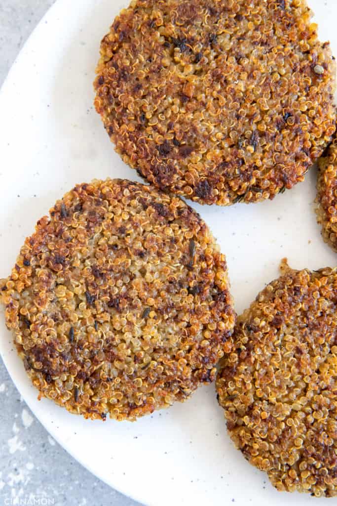 pan-fried glutenfree mushroom quinoa patties on a white plate 